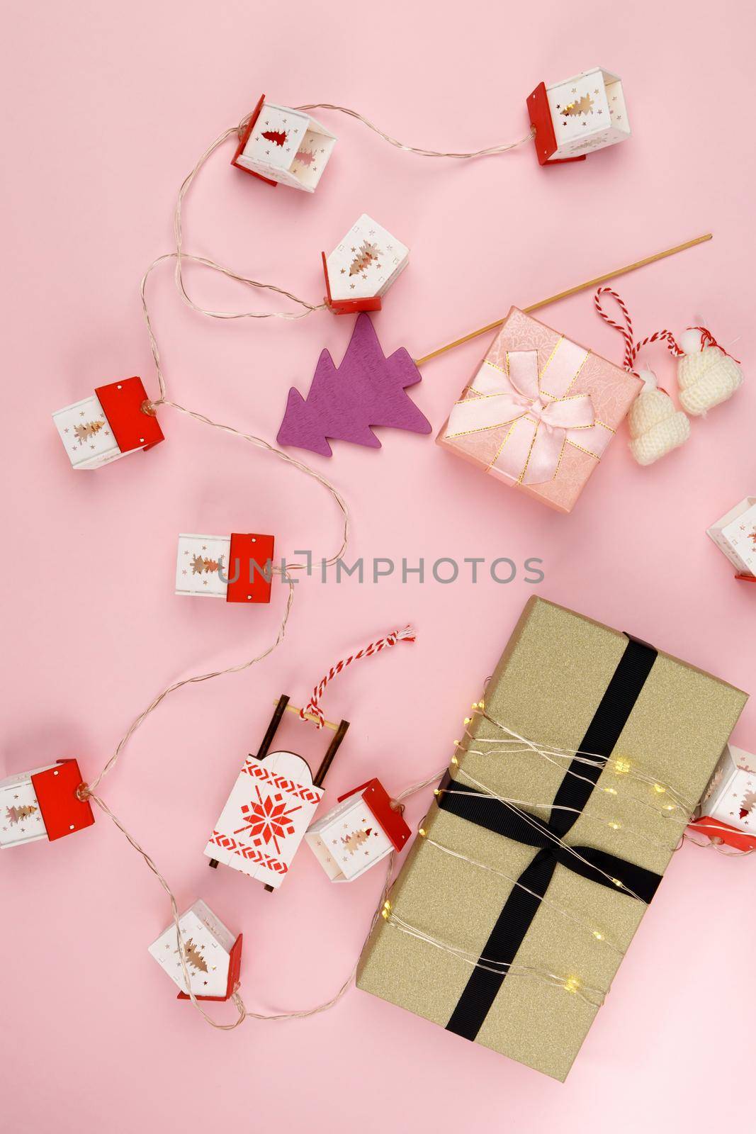Christmas gift boxes Happy Christmas. Winter holiday theme. Happy New Year. Pink background. Flat lay