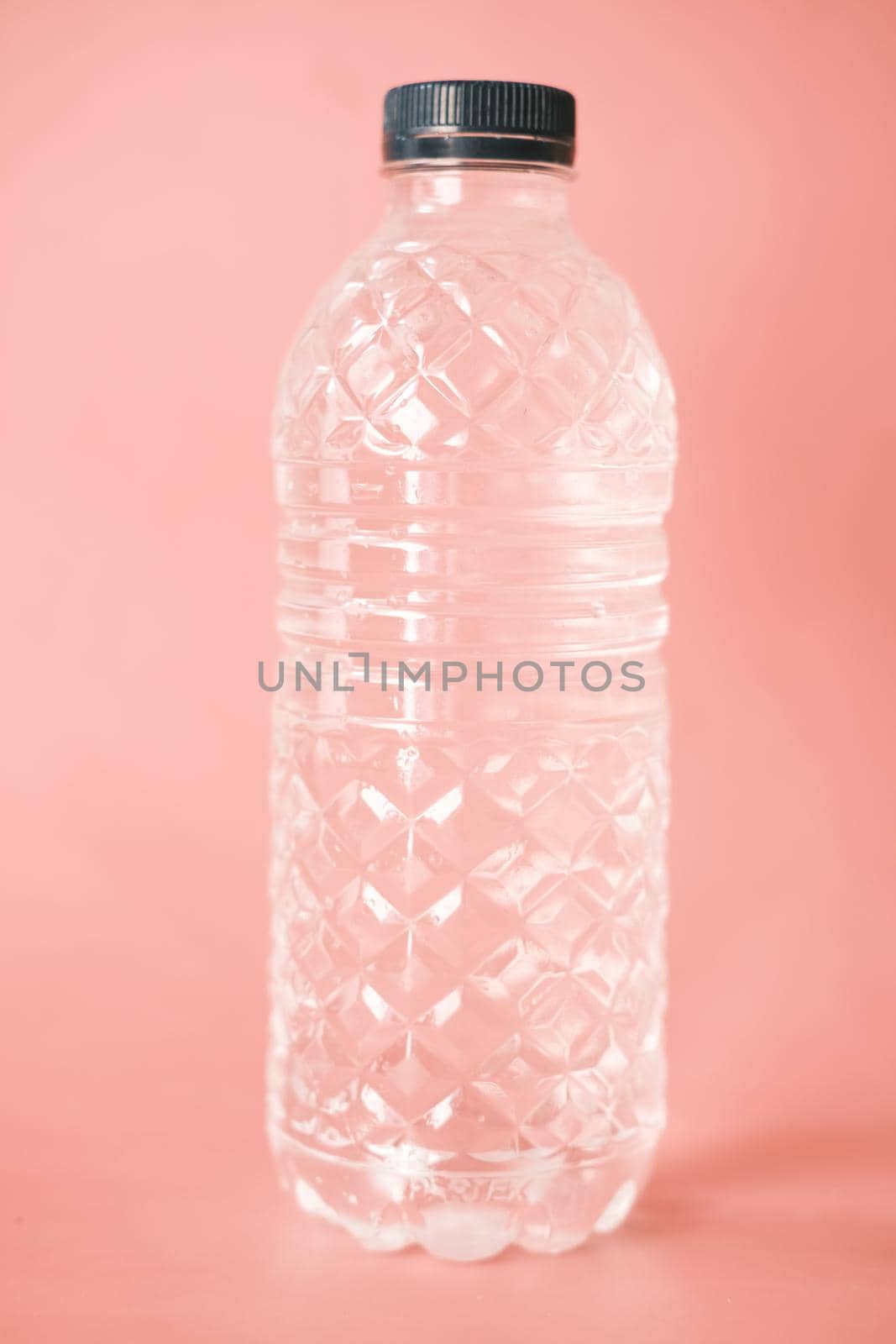 fresh drinking water in a plastic bottle on pink by towfiq007
