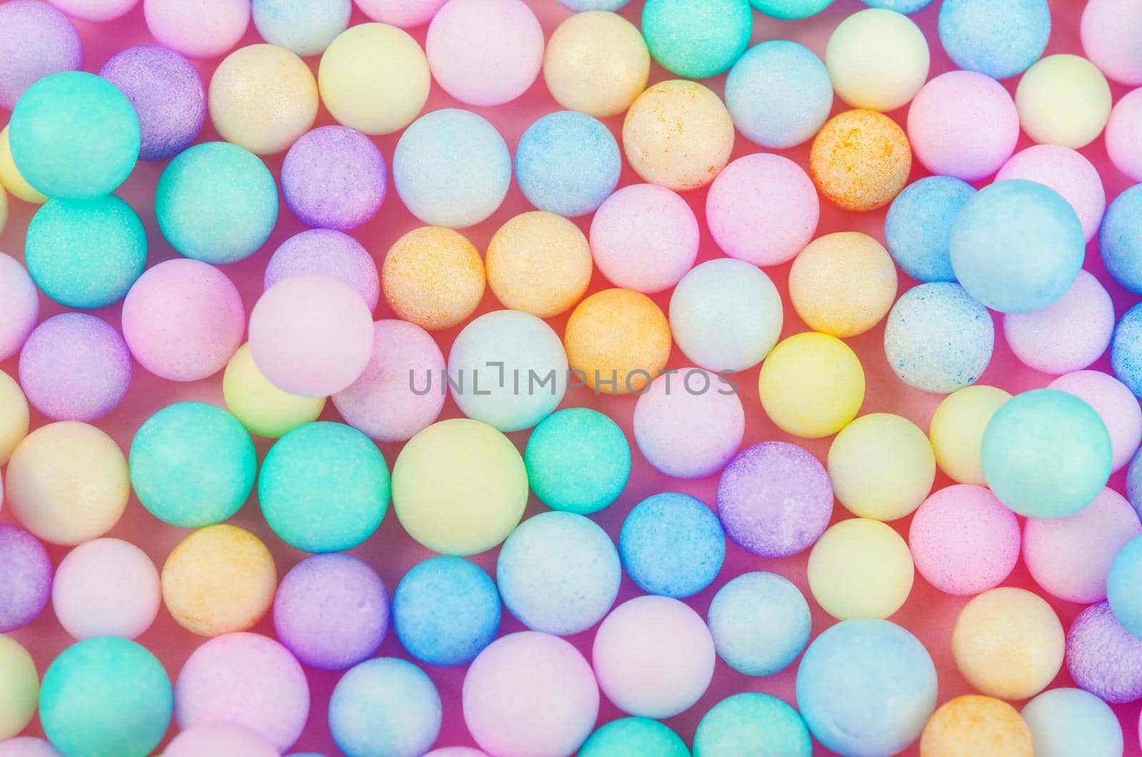 Foam beads of various colors brightly colored abstract background.