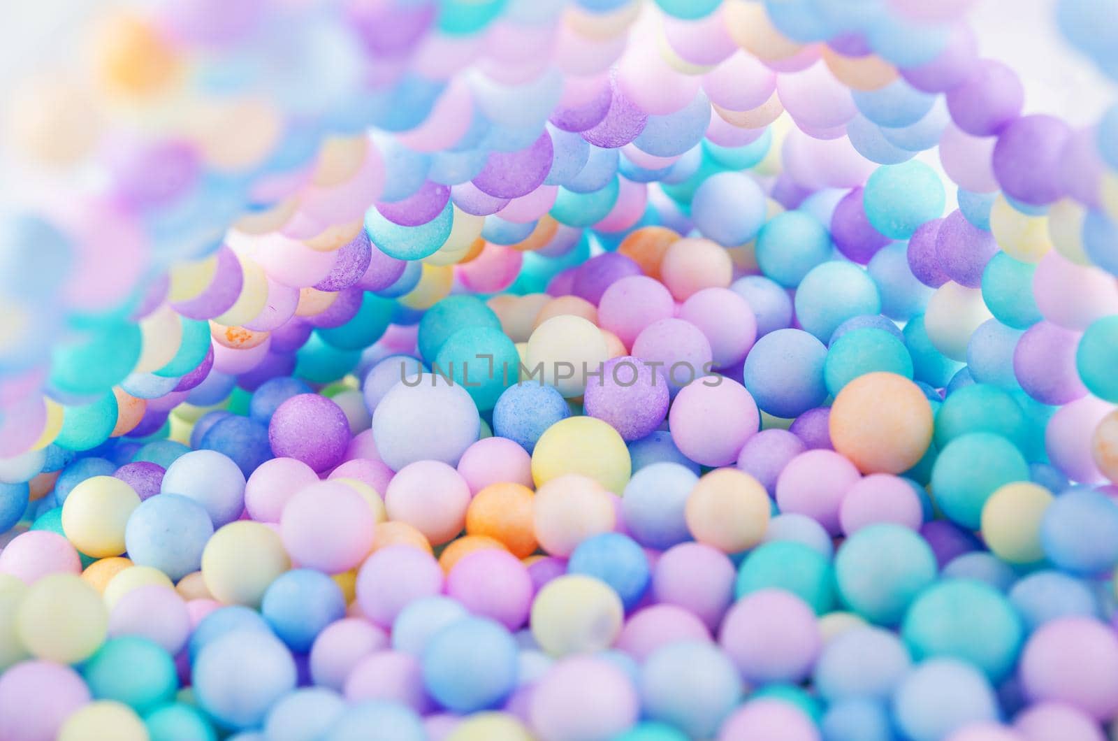 Foam beads of various colors brightly colored abstract background.