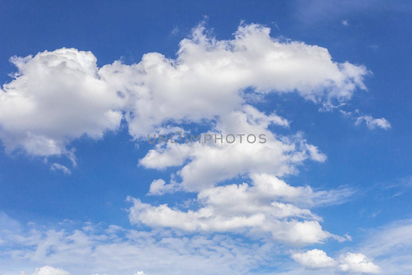 The blue sky background with tiny clouds.