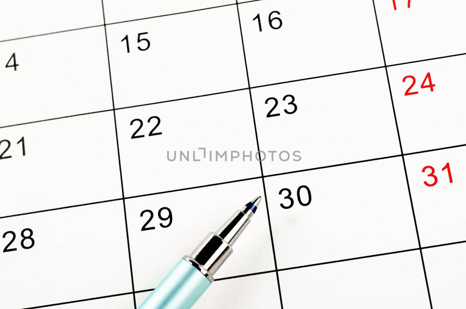 The pen on a blank calendar for your text or message.