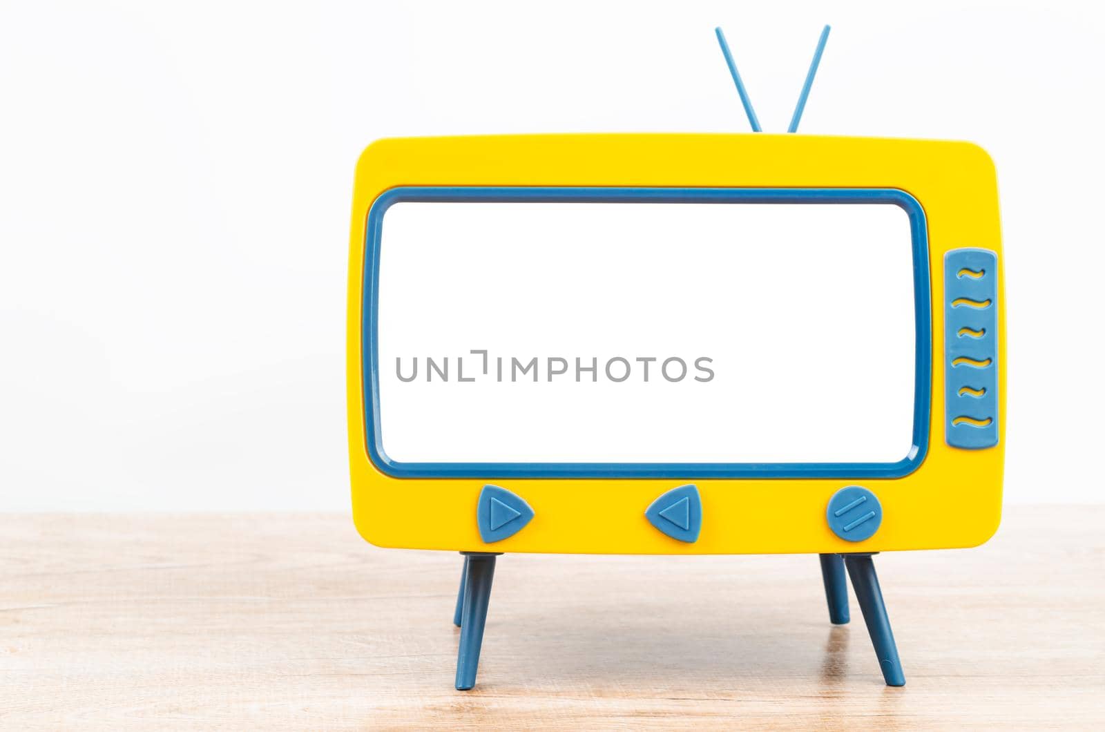 Vintage Miniature Toy Television on wooden table.