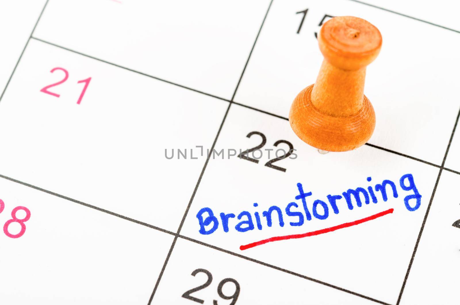 Handwritten Brainstorming for reminde apointment with wooden pin on a calendar.