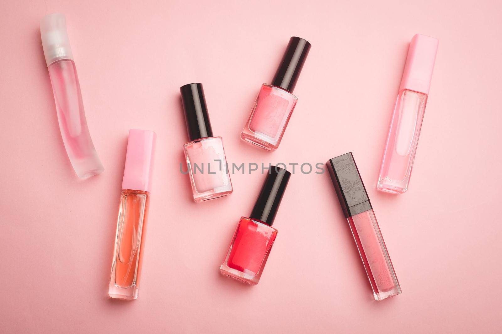 Pink nail polish on a pink copy space background. An article about nail polishes. Gel polish. An article about cosmetics. Decorative cosmetics . by alenka2194