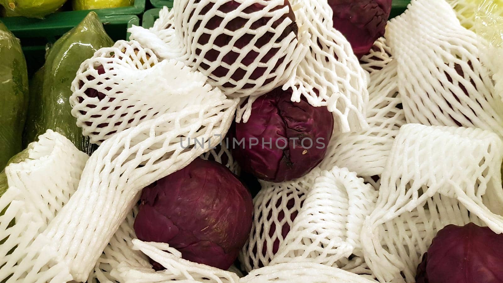 Purple cabbage wrapped in white foam cushioning