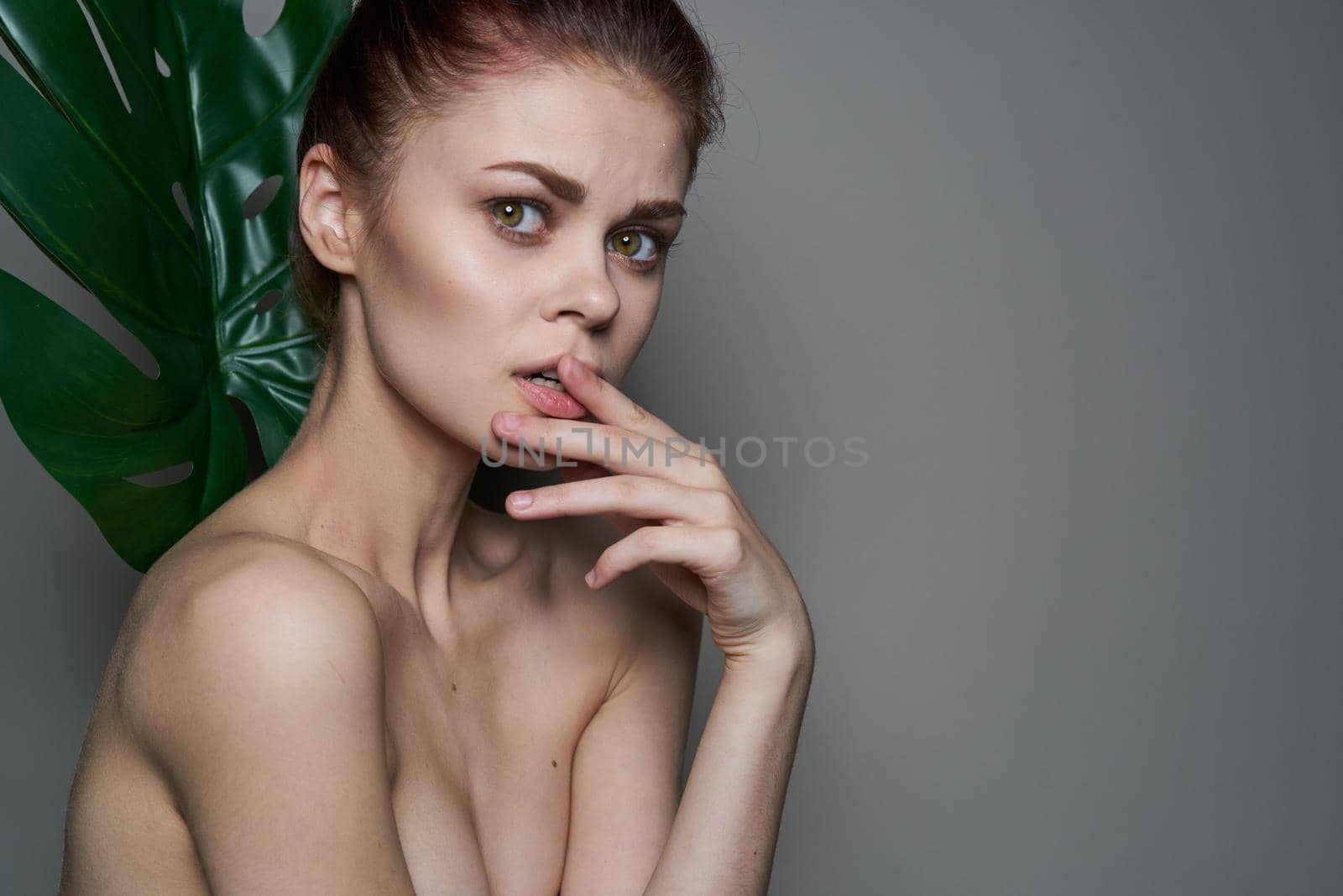 attractive woman clean skin palm leaf health cosmetics. High quality photo