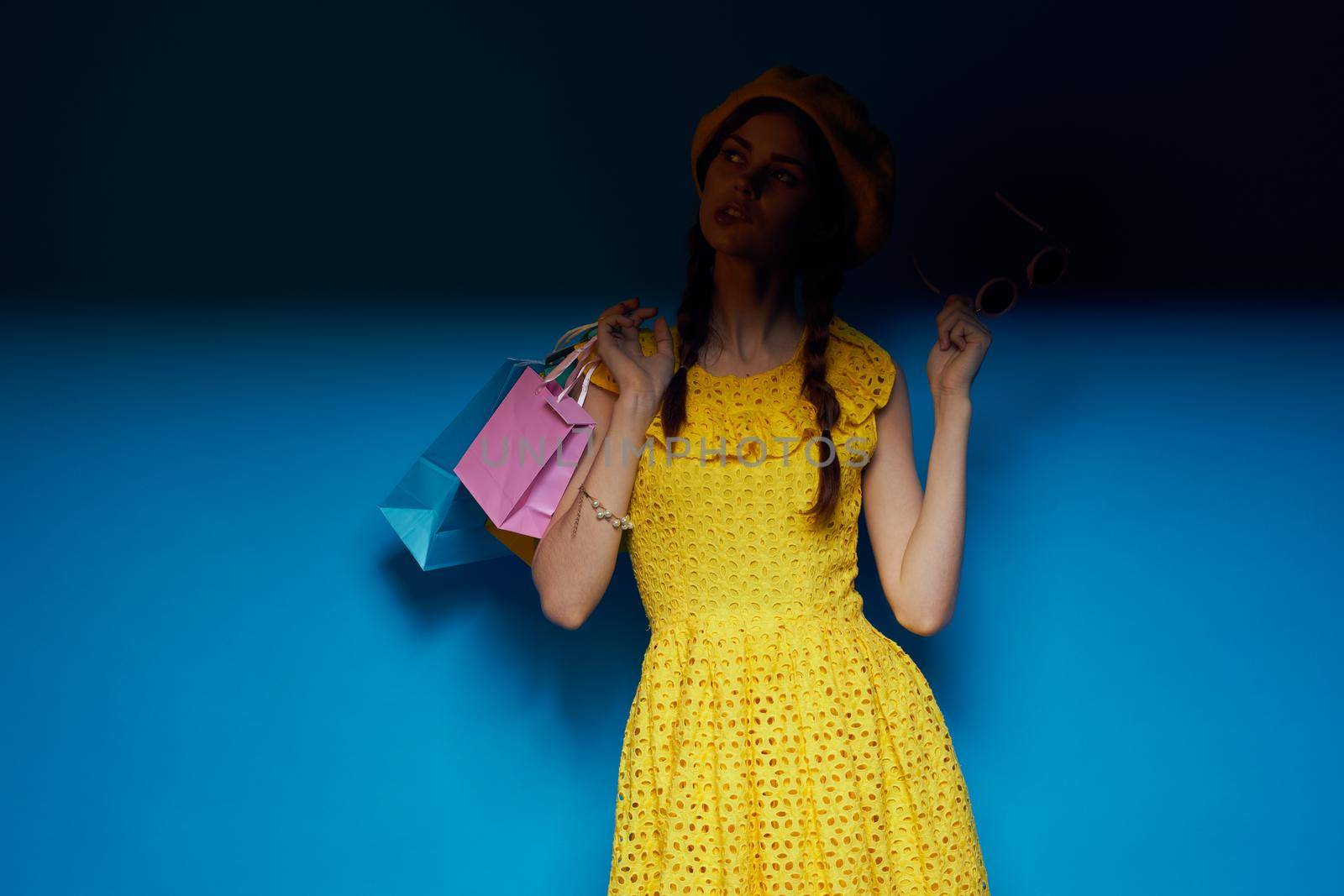 pretty woman in a yellow hat Shopaholic fashion style studio model. High quality photo