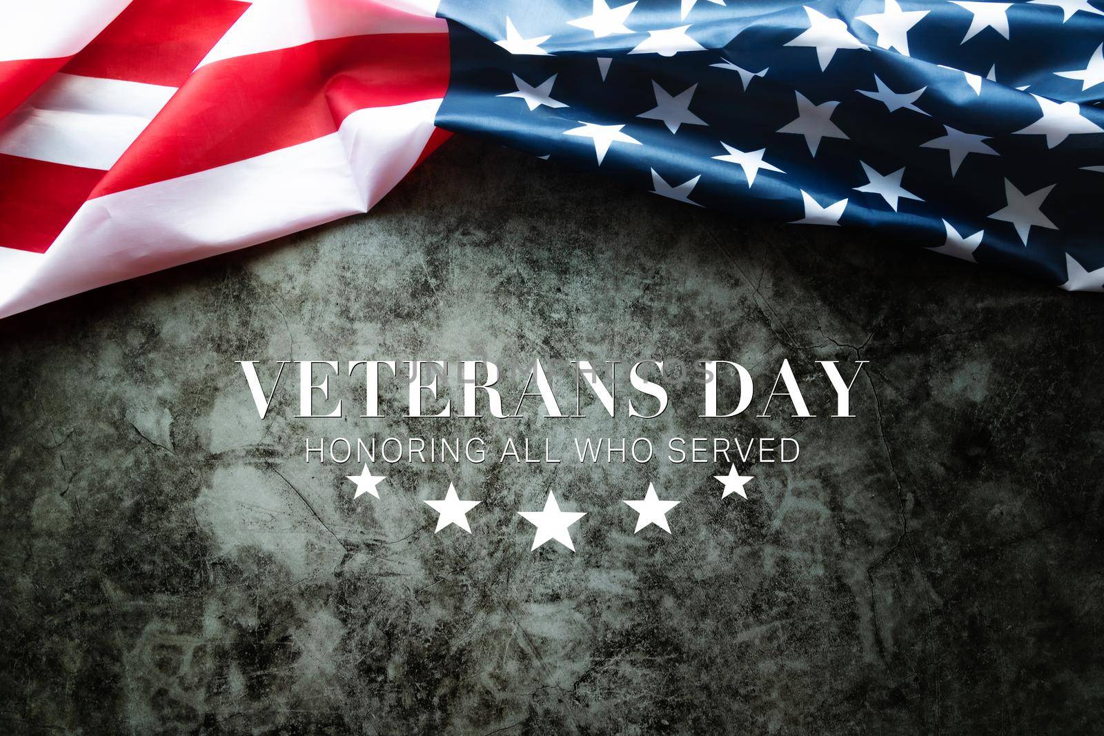 Veterans day. Honoring all who served. American flag on cement background