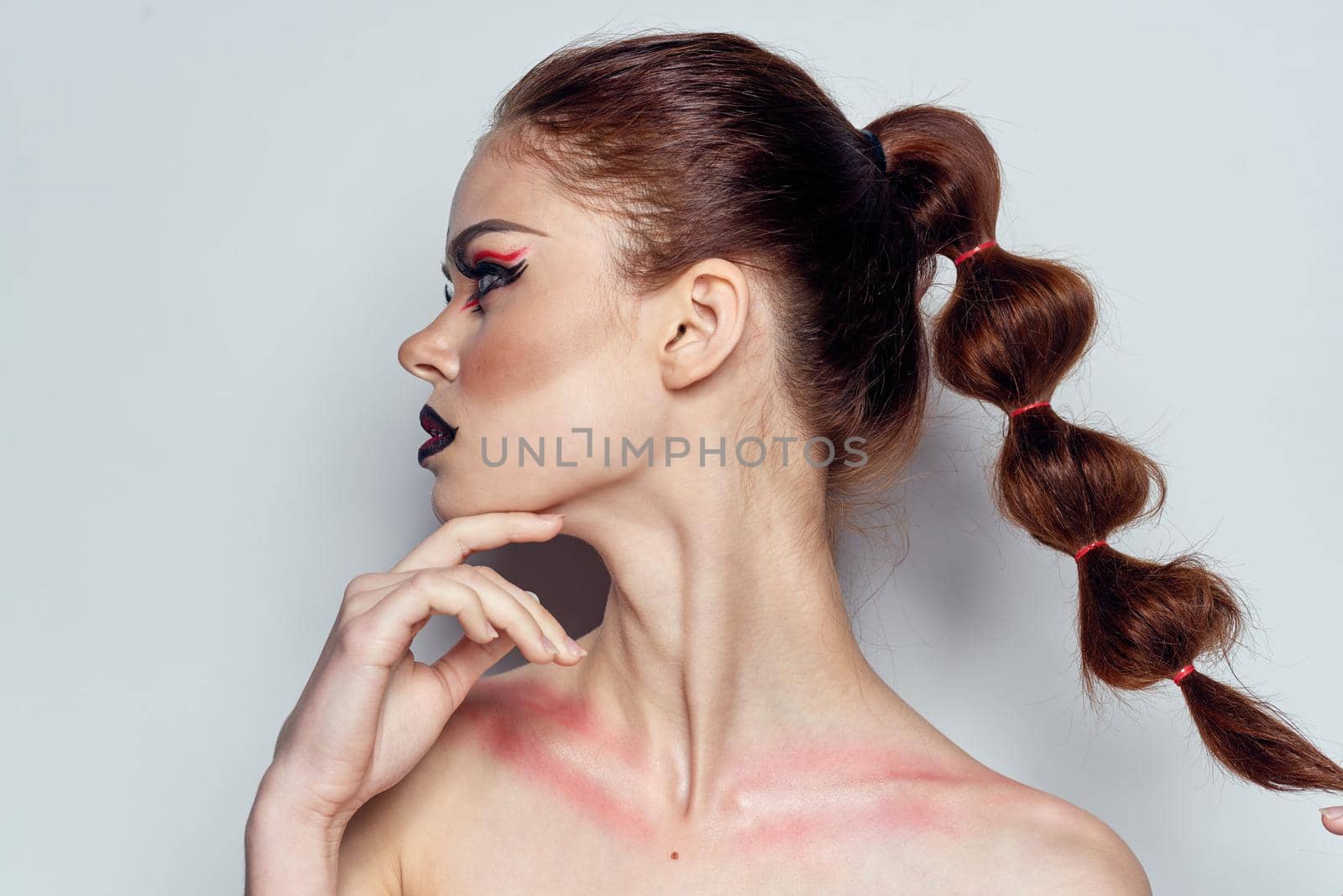 beautiful woman posing scorpio sign on forehead cosmetics light background by Vichizh