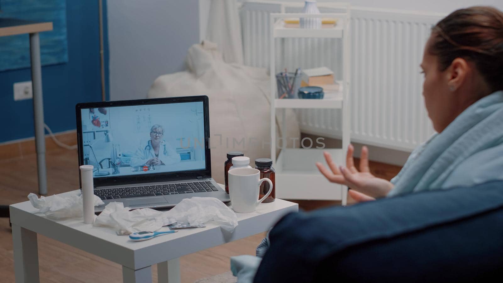 Patient with headache using video call for telemedicine and telehealth, asking doctor about treatment to cure pain and flu symptoms. Woman talking to specialist on online remote conference