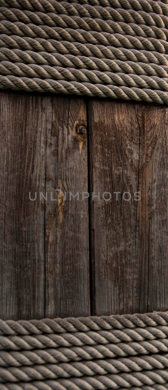 Hemp rope on weathered wood background