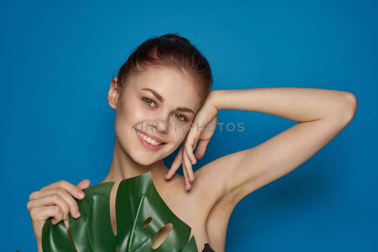 cheerful woman clean skin palm leaf cosmetics studio model by Vichizh