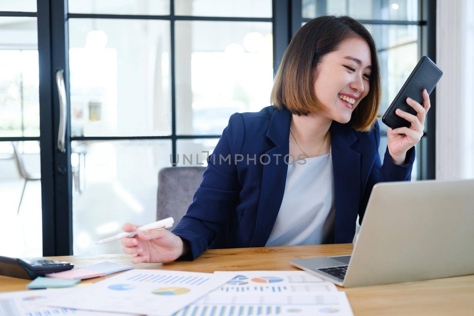 Portrait of beautiful and smart young entrepreneur businesswoman working in modern work station.