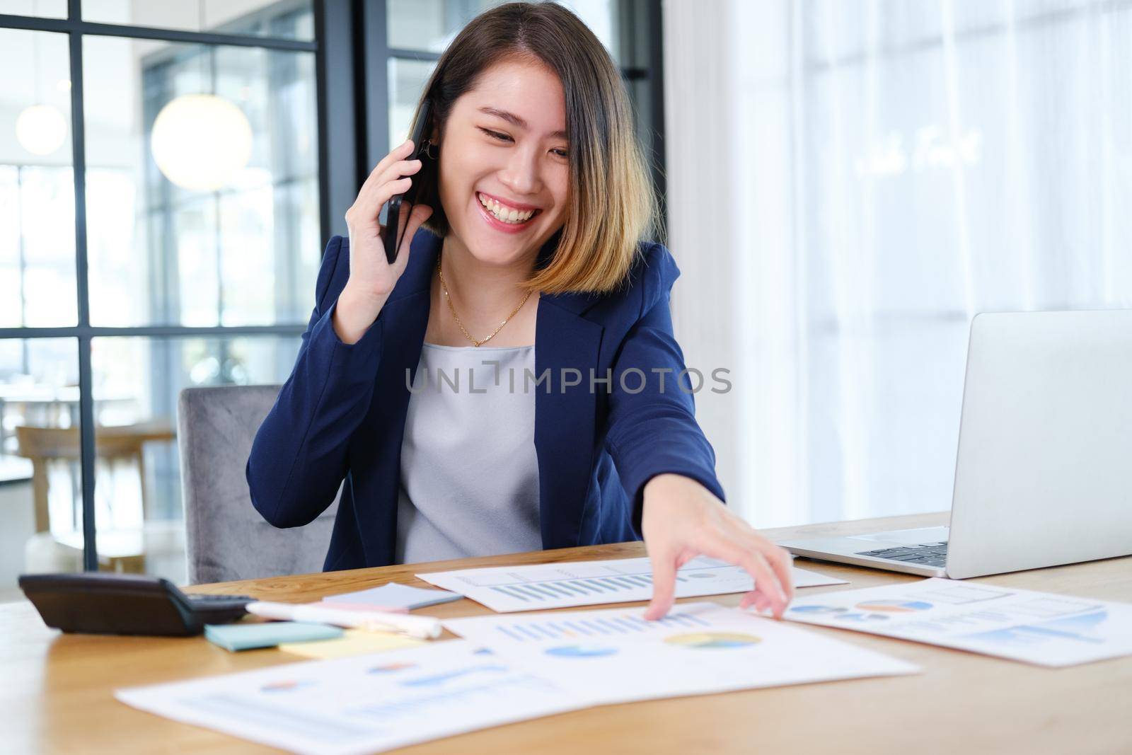 Portrait of beautiful and smart young entrepreneur businesswoman working in modern work station.