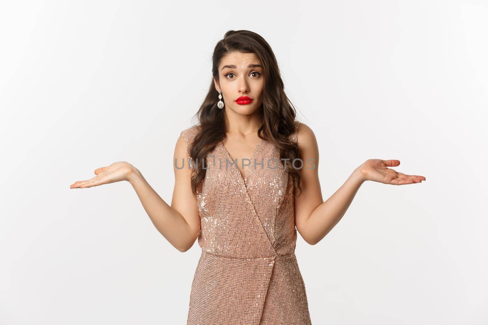 Concept of casino, celebration and party. Confused beautiful woman in glamour dress looking indecisive, shrugging clueless, standing over white background by Benzoix
