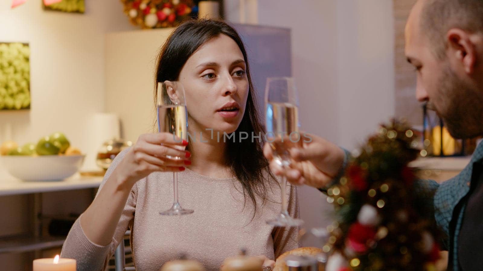 Close up of woman eating food and clinking glass of champagne by DCStudio