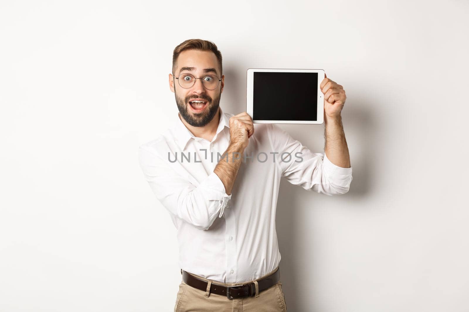 Shopping and technology. Handsome man showing digital tablet screen, wearing glasses with white collar shirt, studio background by Benzoix