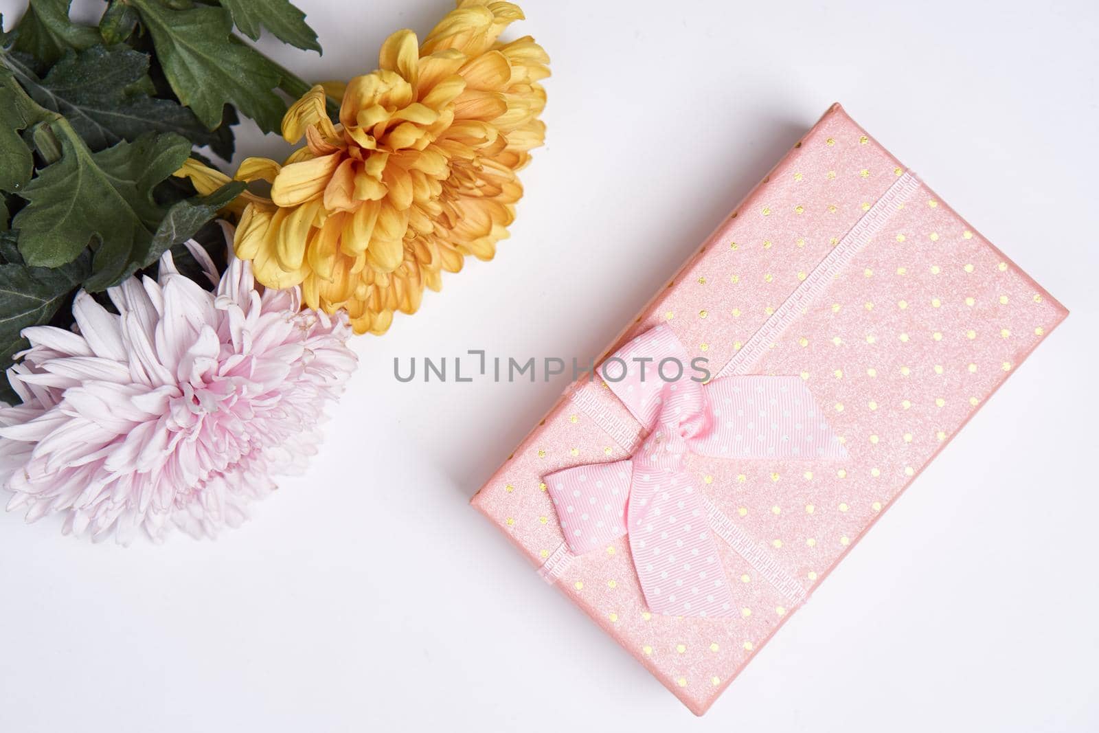 pink gift box flower bouquet holiday light background by Vichizh