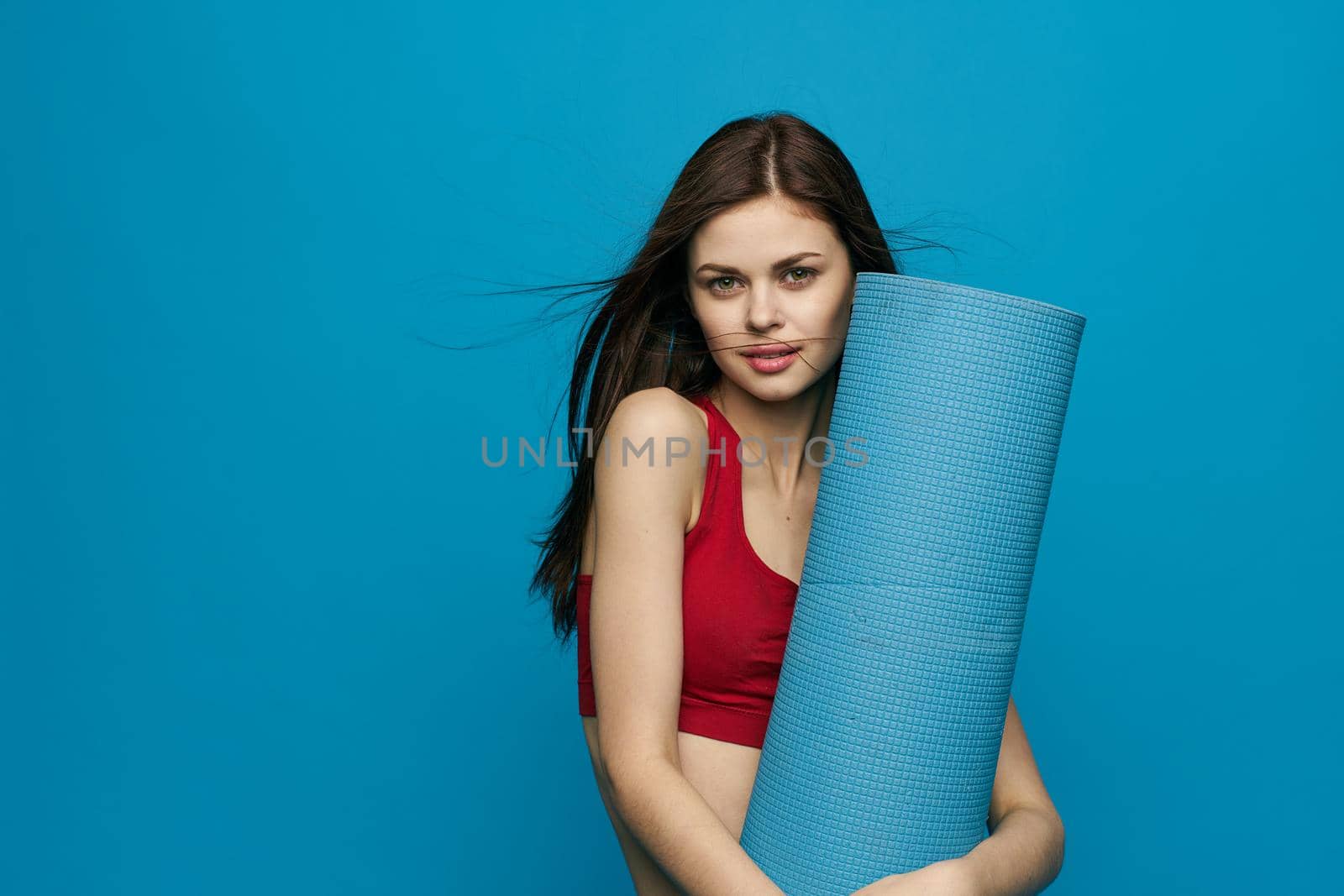 athletic woman sport equipment training blue background. High quality photo