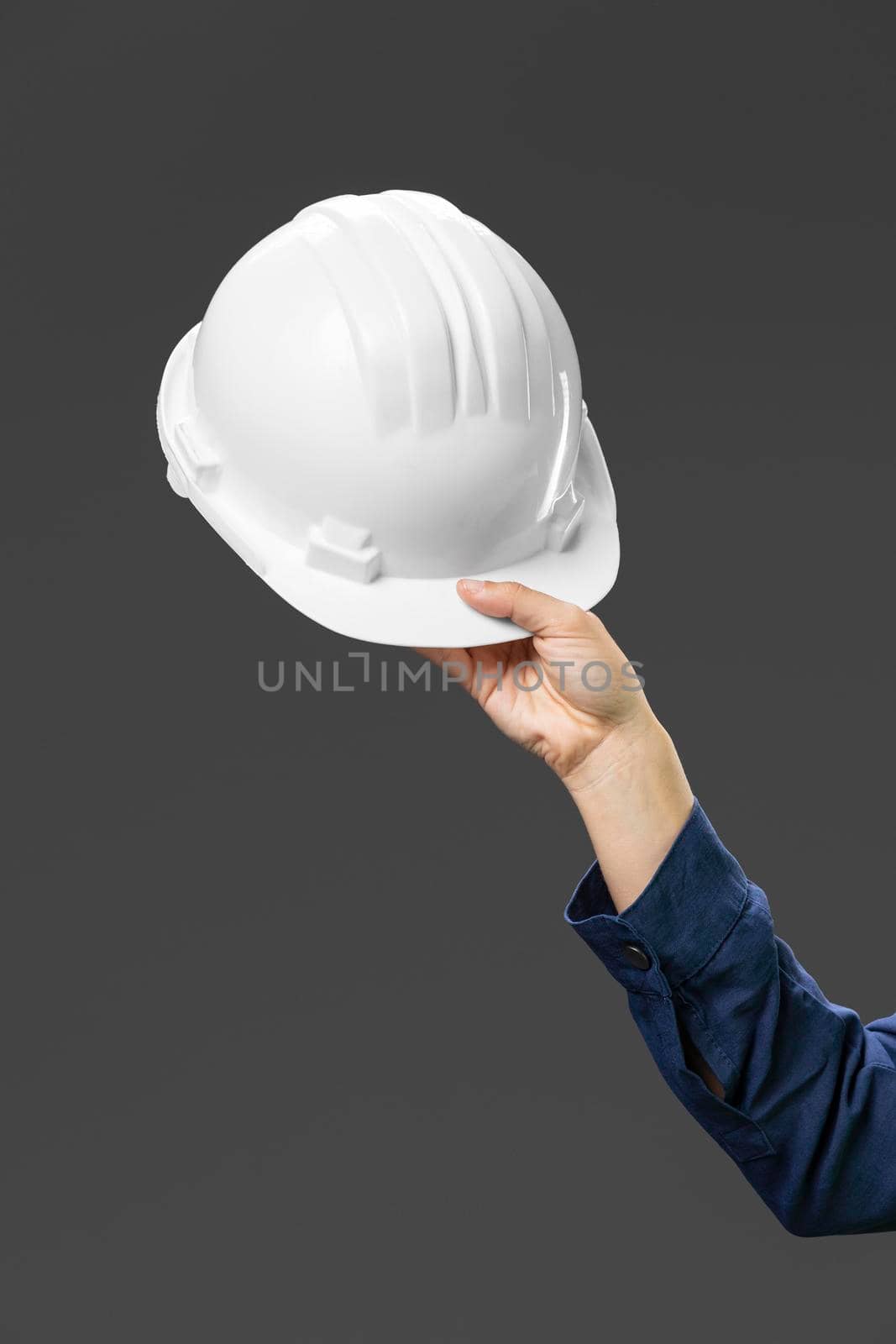 portrait female engineer holding helmet close up. High resolution photo