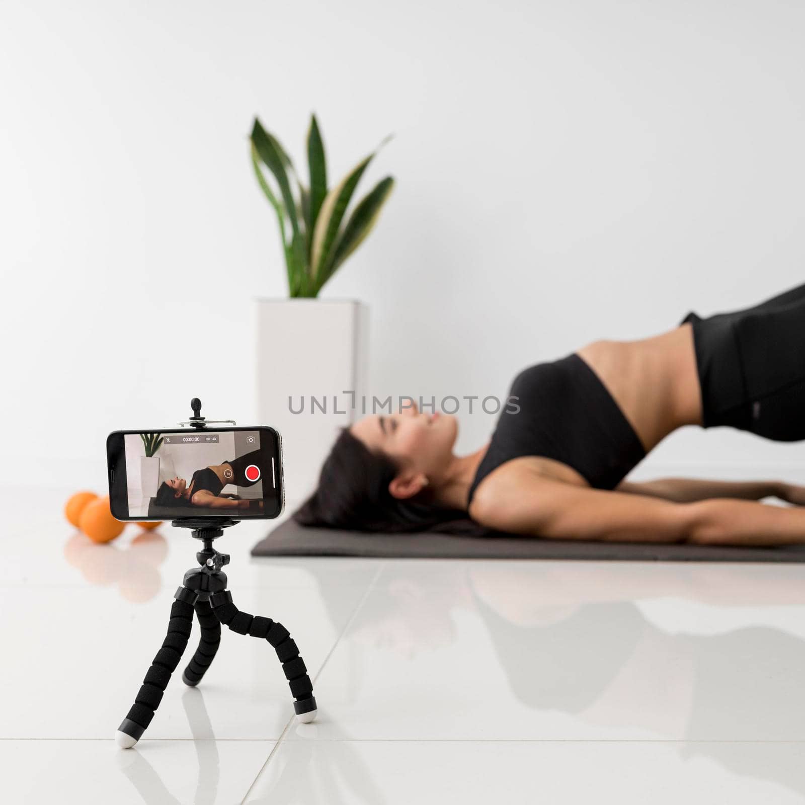 female influencer home exercising. High resolution photo