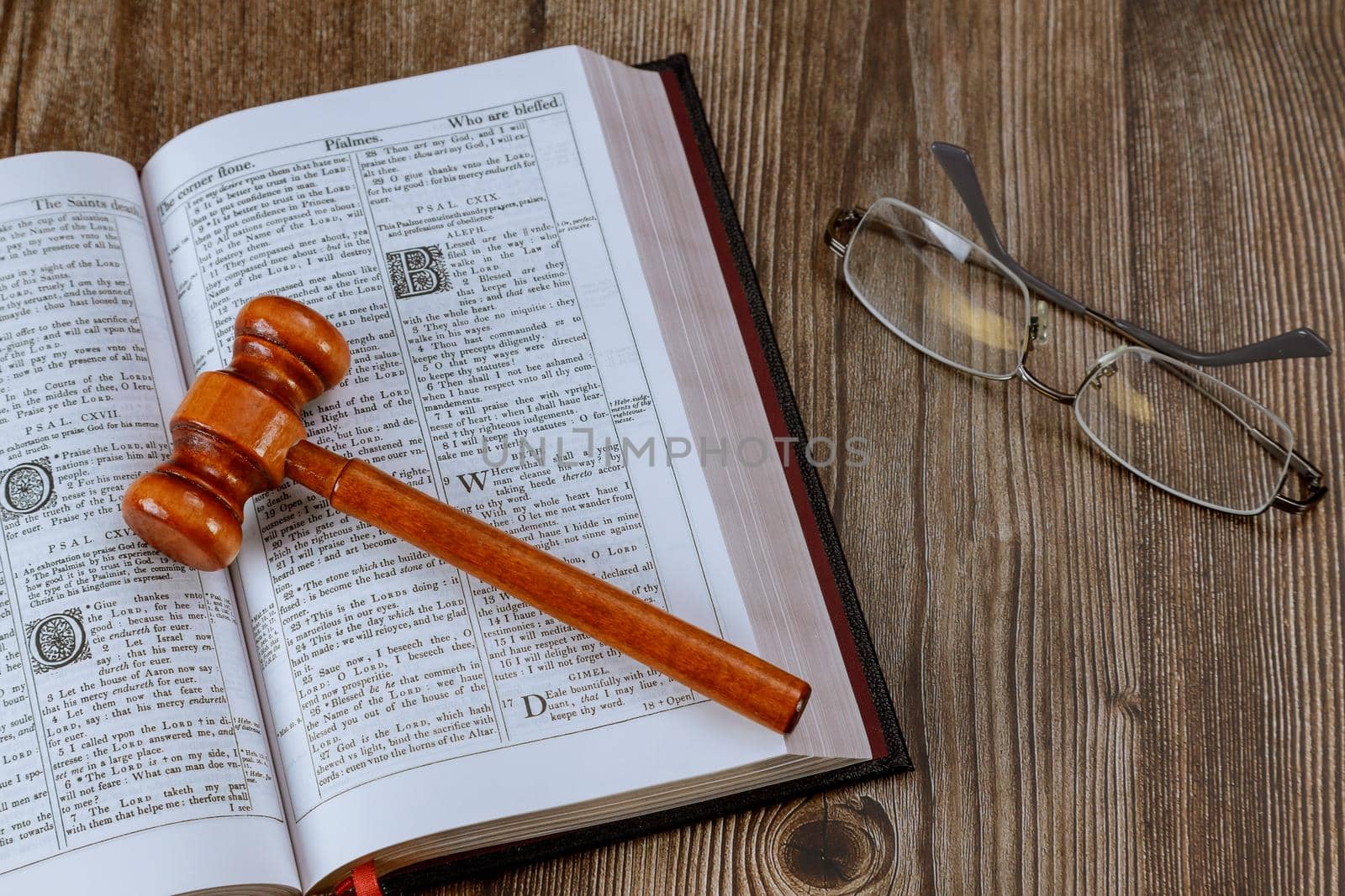Close up of judge gavel on Bible world book on wooden table Christian God justice by ungvar