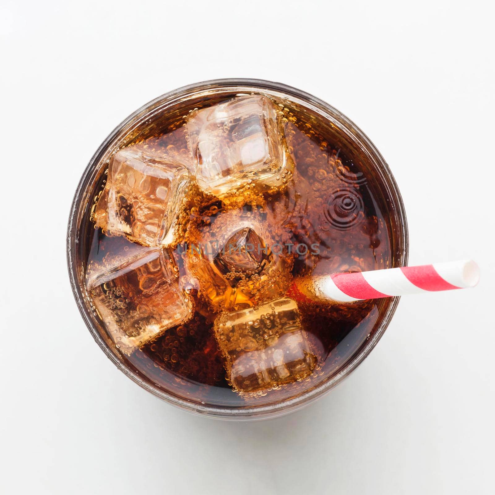 top view soft drink glass with ice cubes straw. High resolution photo