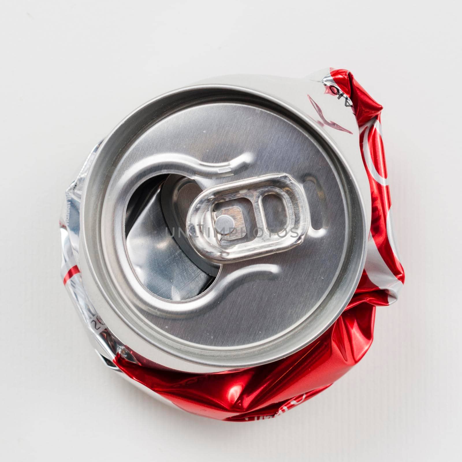crumpled drink can grey background. High resolution photo