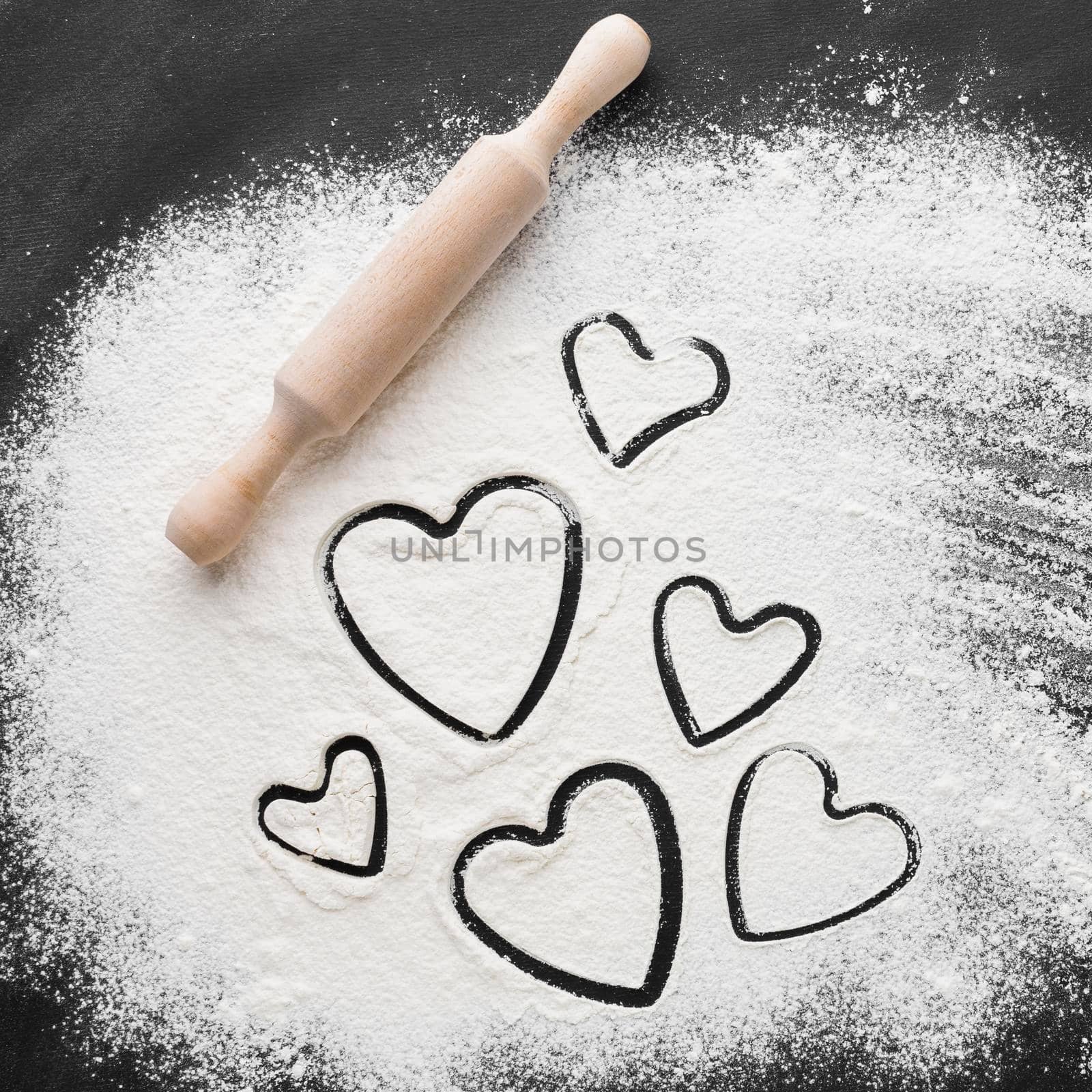 flat lay heart shapes flour with rolling pin. High quality photo by Zahard