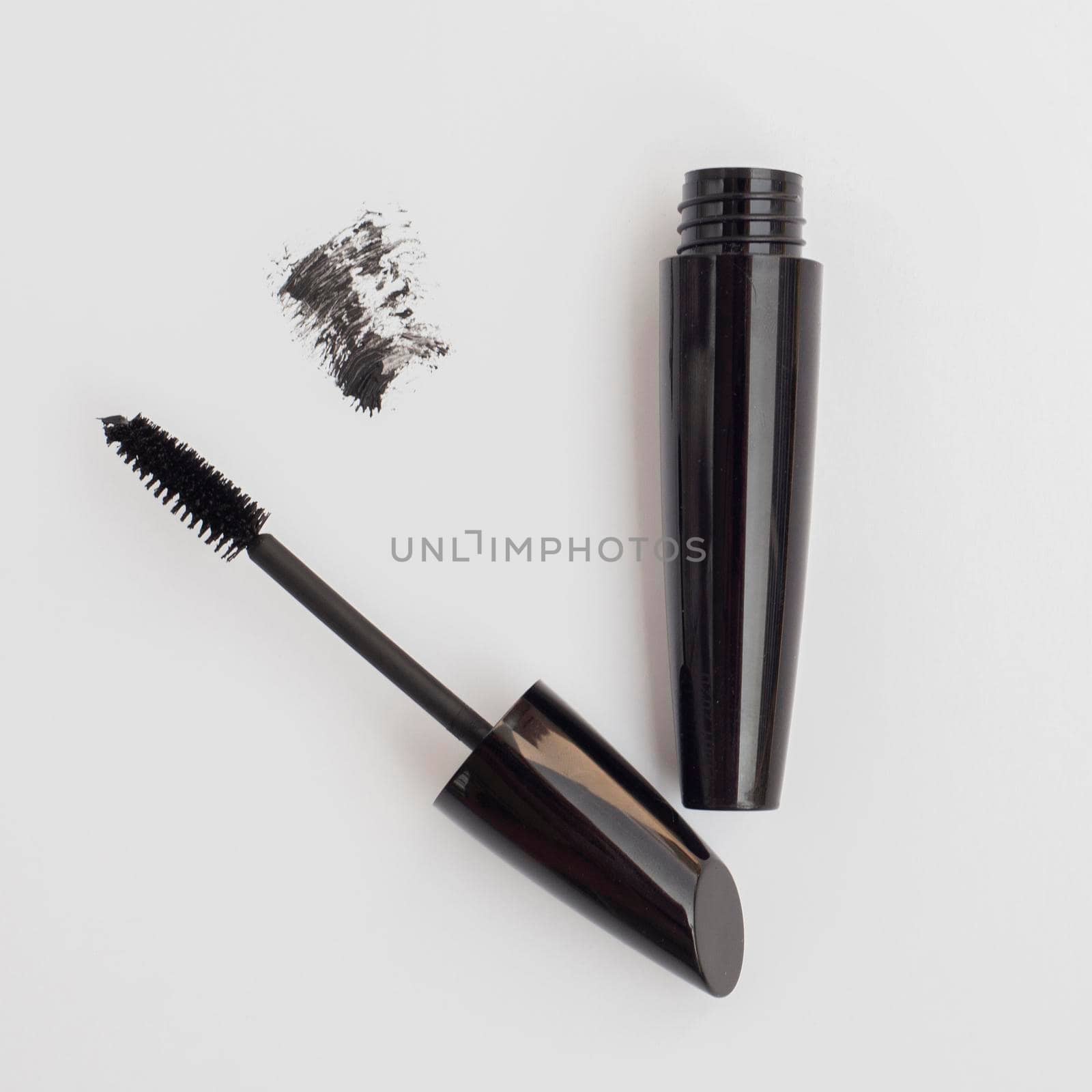 top view black mascara with grey background. High quality photo by Zahard