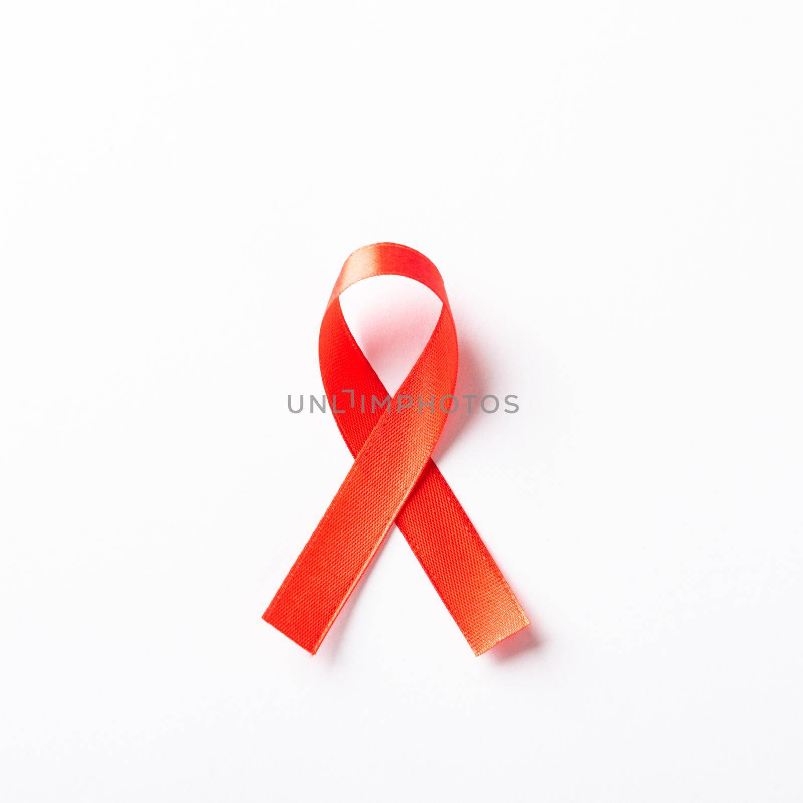 Red bow ribbon symbol HIV, AIDS cancer awareness with shadows, studio shot isolated on white background, Healthcare medicine concept, World AIDS Day