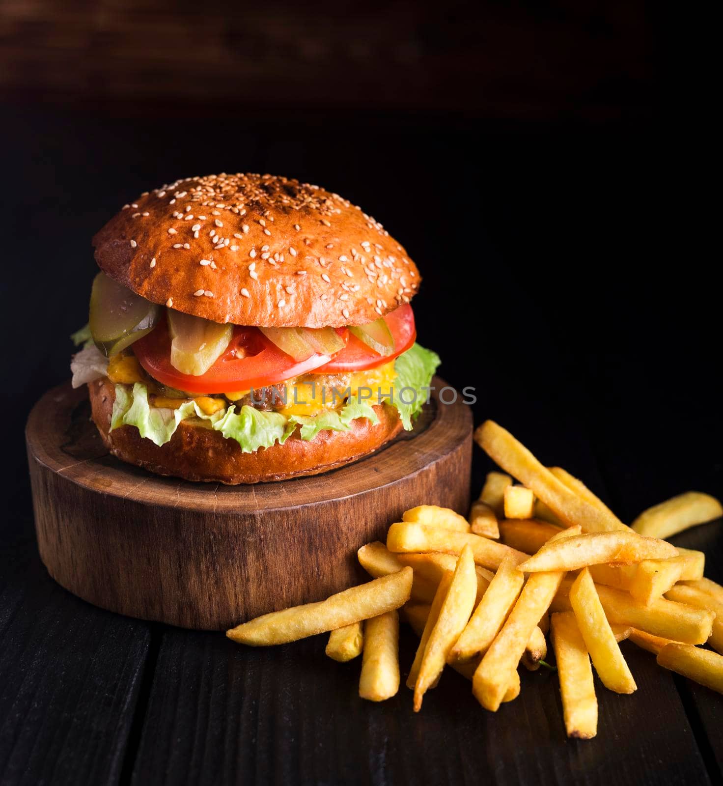 beef hamburger ready be served with fries. High resolution photo