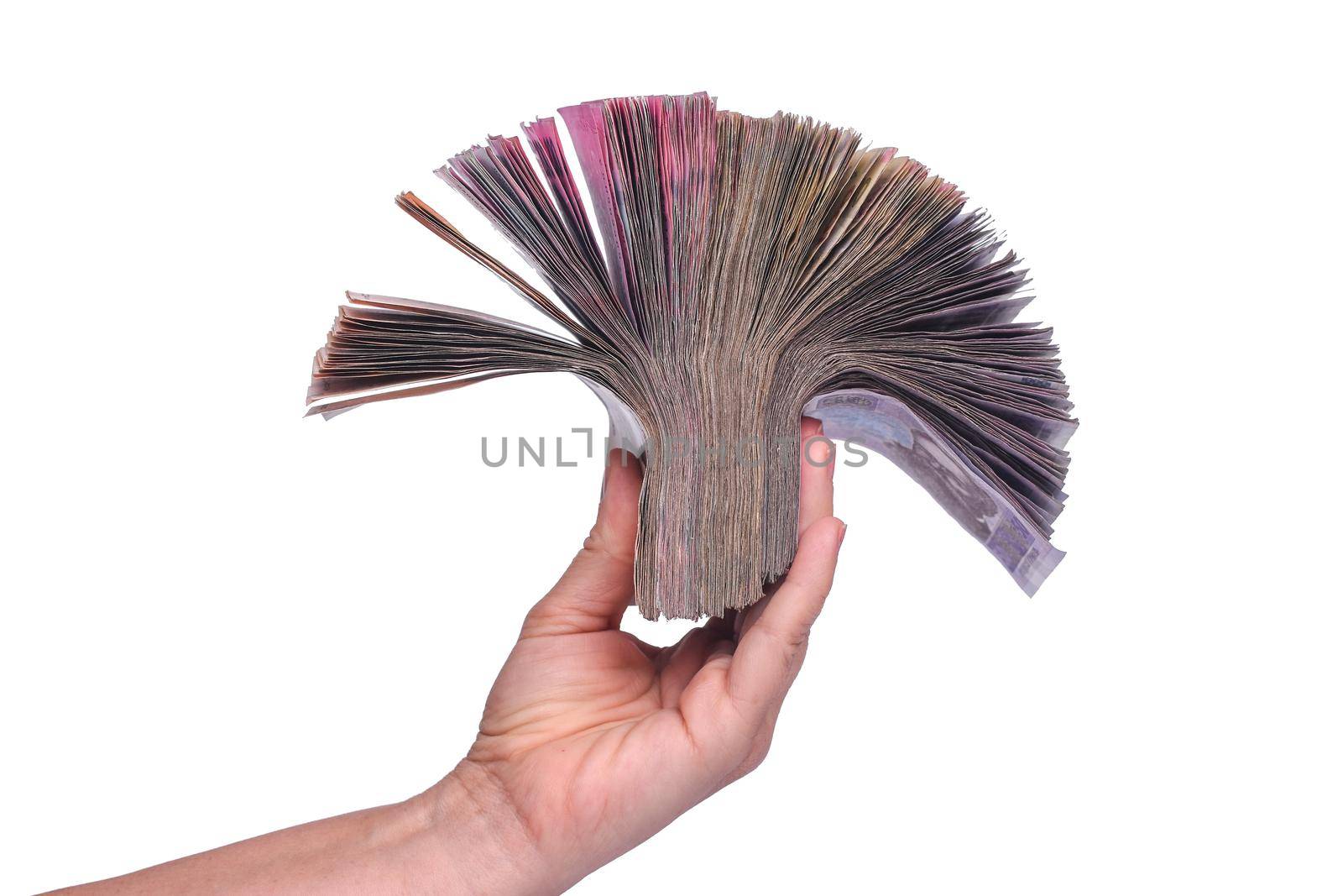 a wad of banknotes in her hand on a white background. Ukrainian hryvnia, paper money. isolated.