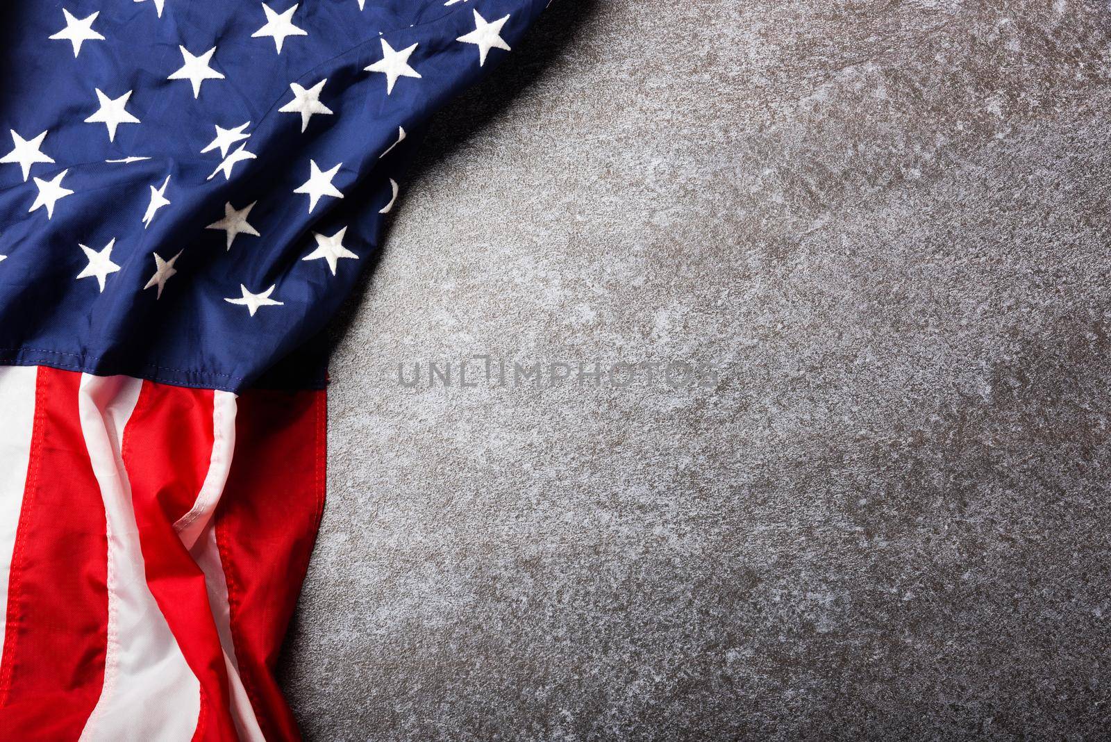 Top view overhead America United States flag, memorial remembrance and thank you of hero, studio shot with copy space concrete board background, USA holiday Veterans or Independence day concept