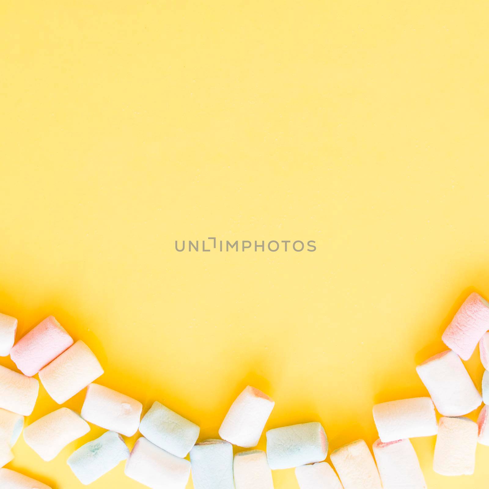 soft marshmallows edge yellow background. High resolution photo
