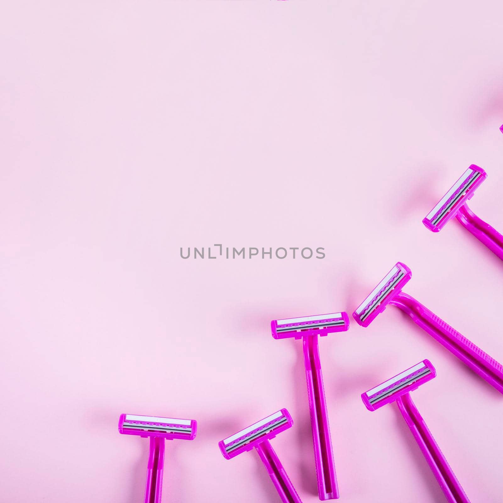 high angle view razors pink backdrop. High quality photo by Zahard