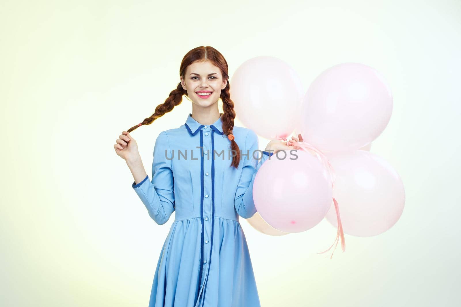 pretty woman with pigtails decoration holiday fun light background. High quality photo