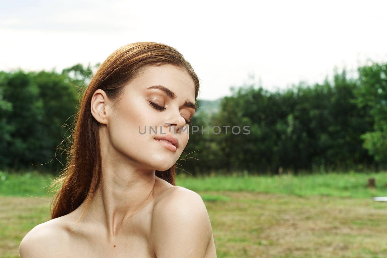 portrait of a woman in a field outdoors bare shoulders clear skin close-up by Vichizh
