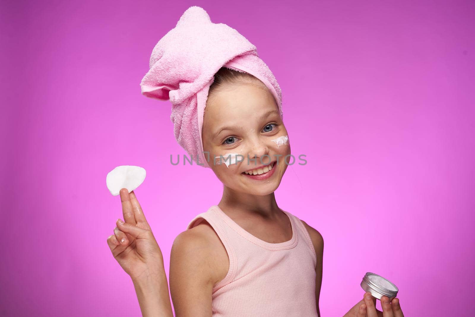 girl with a towel on her head cosmetics decoration close-up purple background. High quality photo