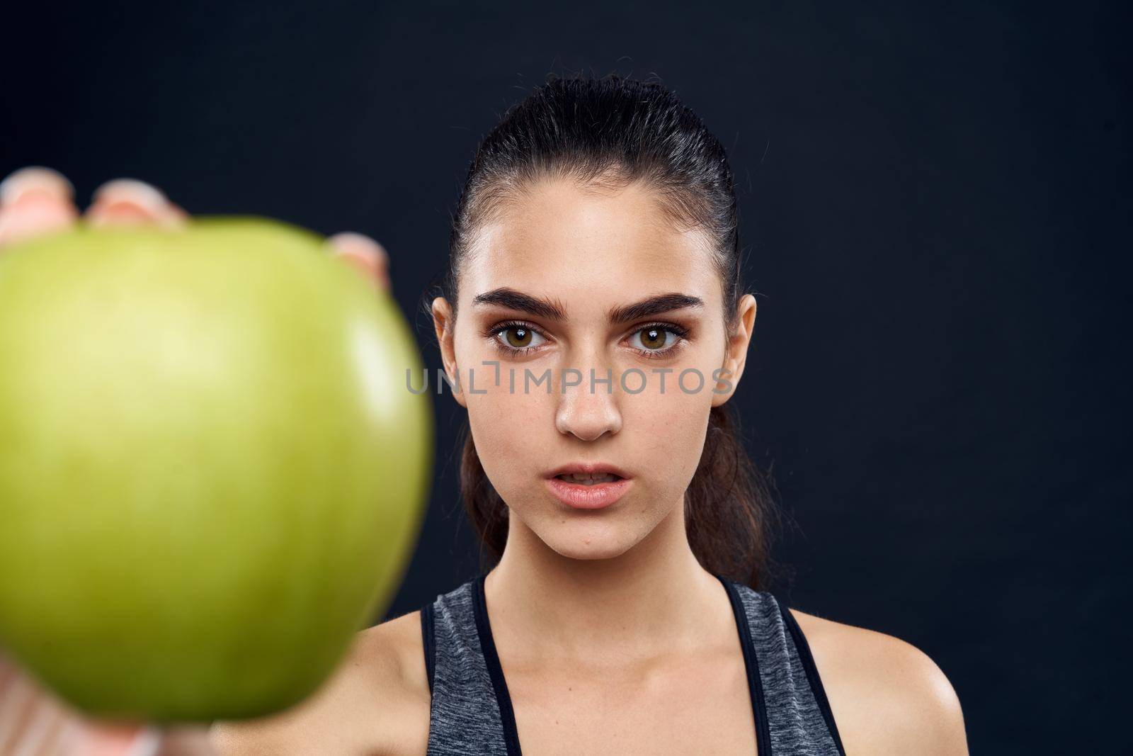 athletic woman slim figure green apple health. High quality photo