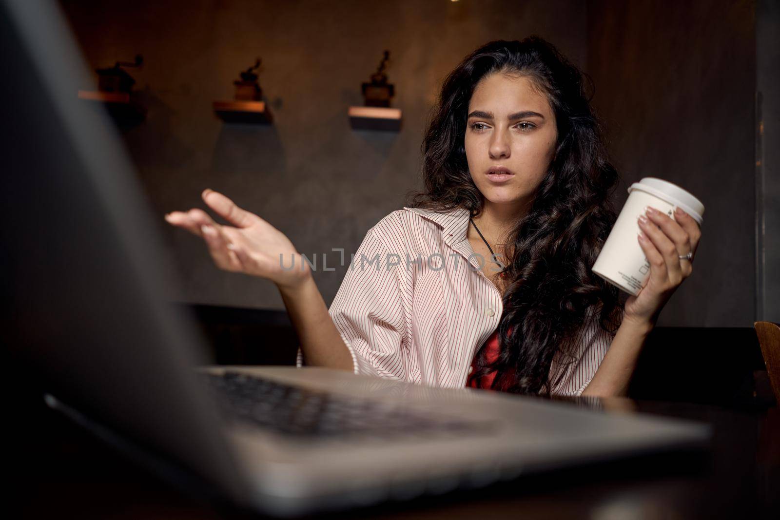 pretty woman in cafe in front of laptop working technology. High quality photo