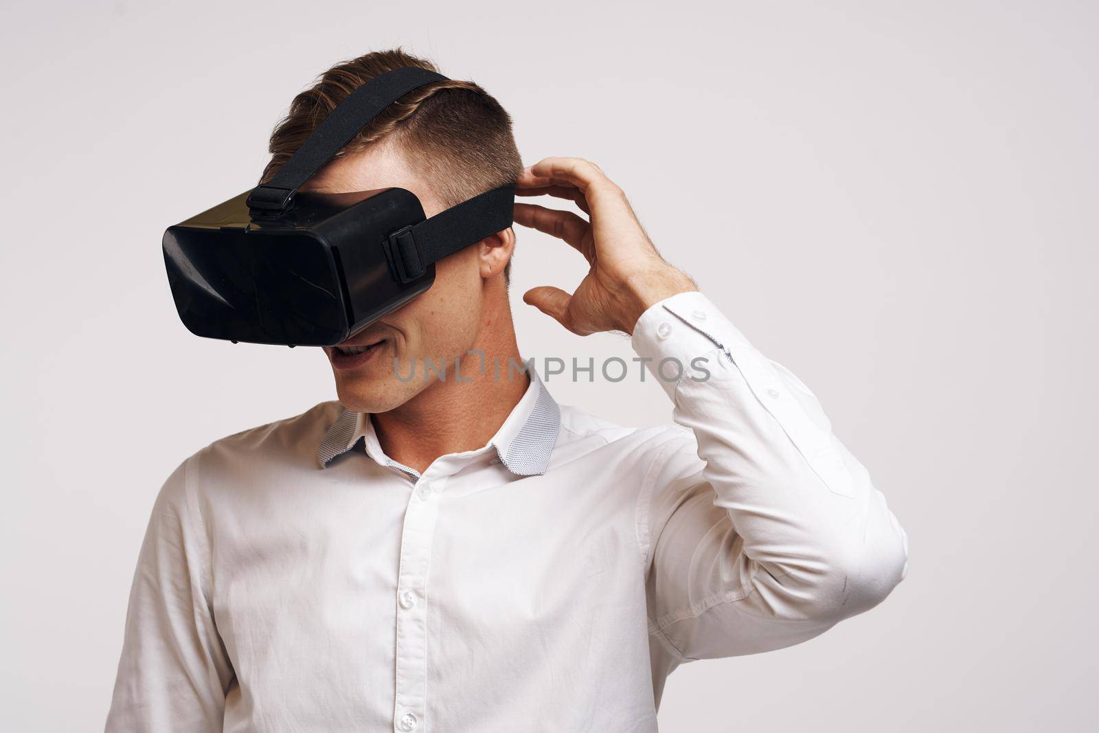 pretty man virtual reality glasses high-tech simulator technology studio. High quality photo