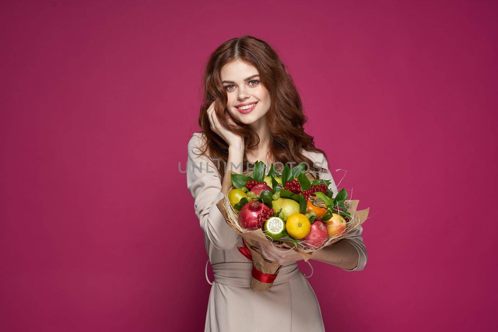 beautiful woman bright makeup attractive look a bouquet of fruits pink background by Vichizh