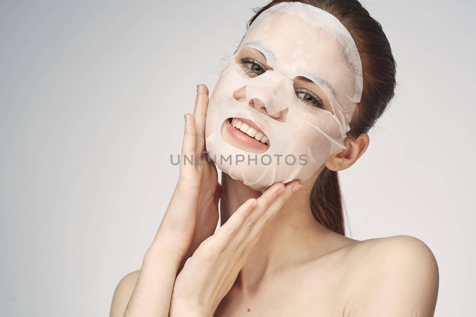 emotional woman cosmetic face mask close-up light background by Vichizh