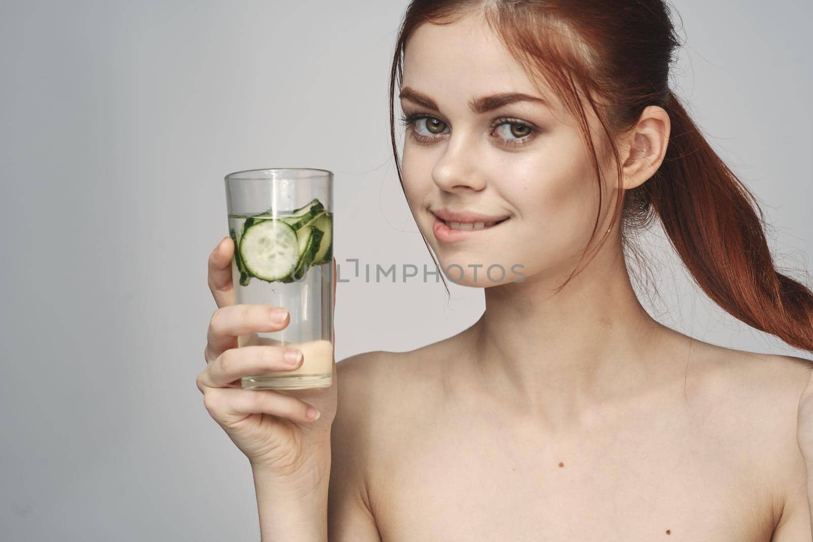 woman with cucumber drink health vitamins close-up by Vichizh