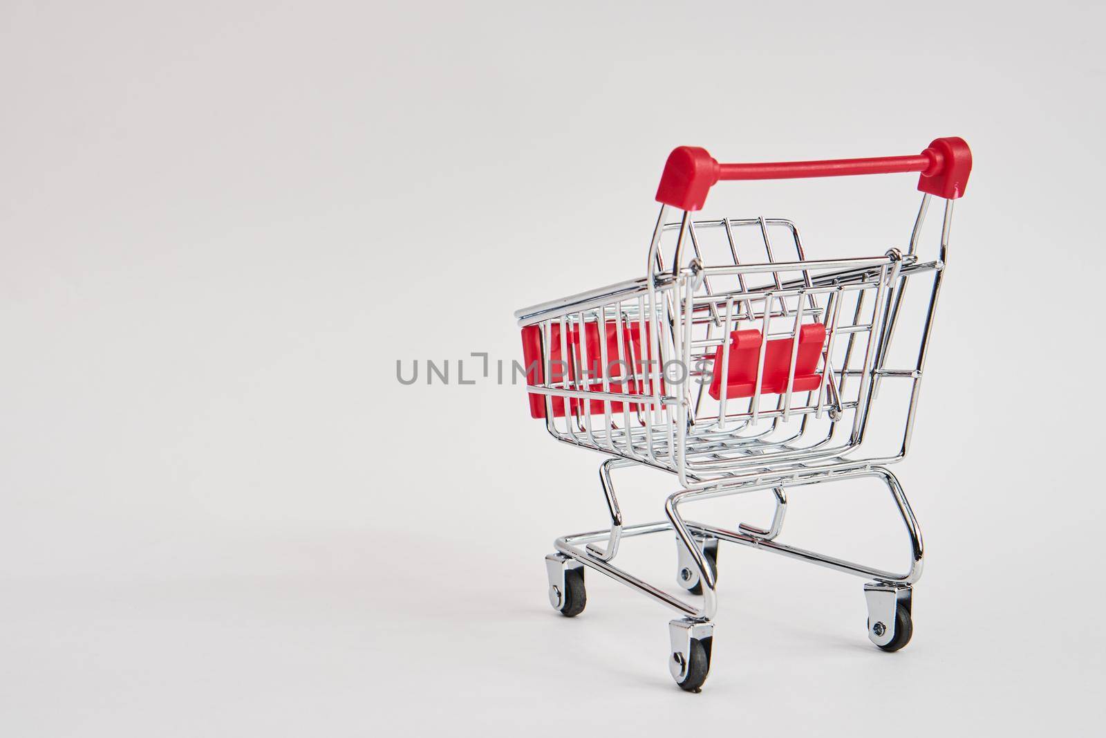 empty trolley on light background shopping supermarket service by Vichizh