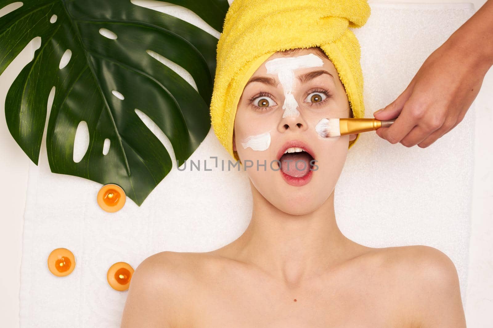attractive woman face mask skin cleansing palm leaf light background by Vichizh