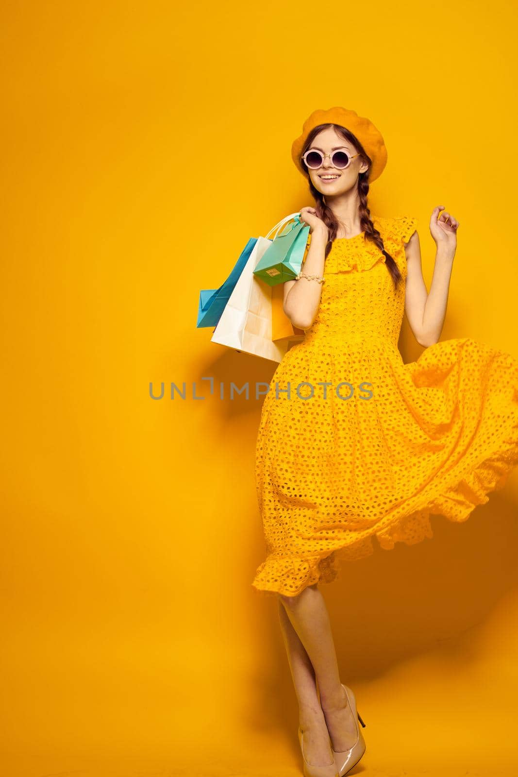 pretty woman shopping entertainment lifestyle yellow background. High quality photo