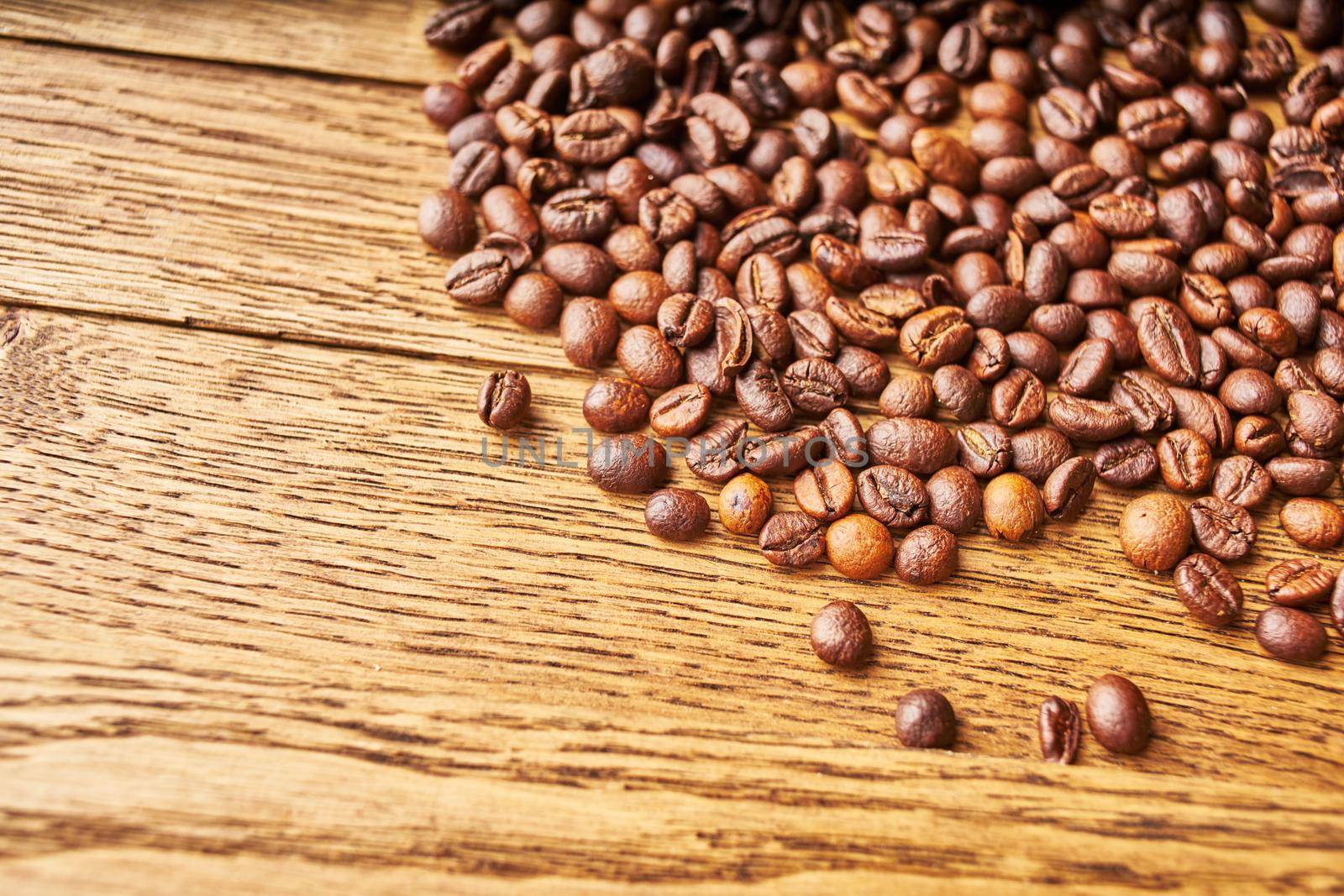 coffee beans Hot drink spilled grains wood background. High quality photo